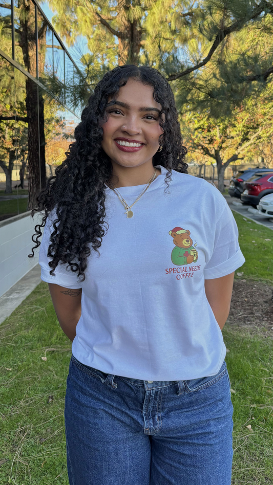 Woman wearing a white t-shirt with a graphic design outdoors